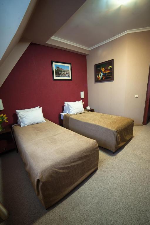 Postel nebo postele na pokoji v ubytování Hotel Praha