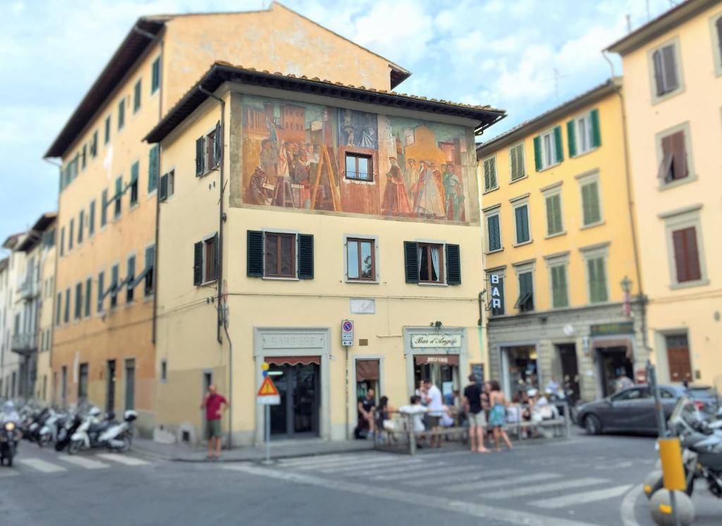 a building with a painting on the side of it at La casetta dipinta in Florence