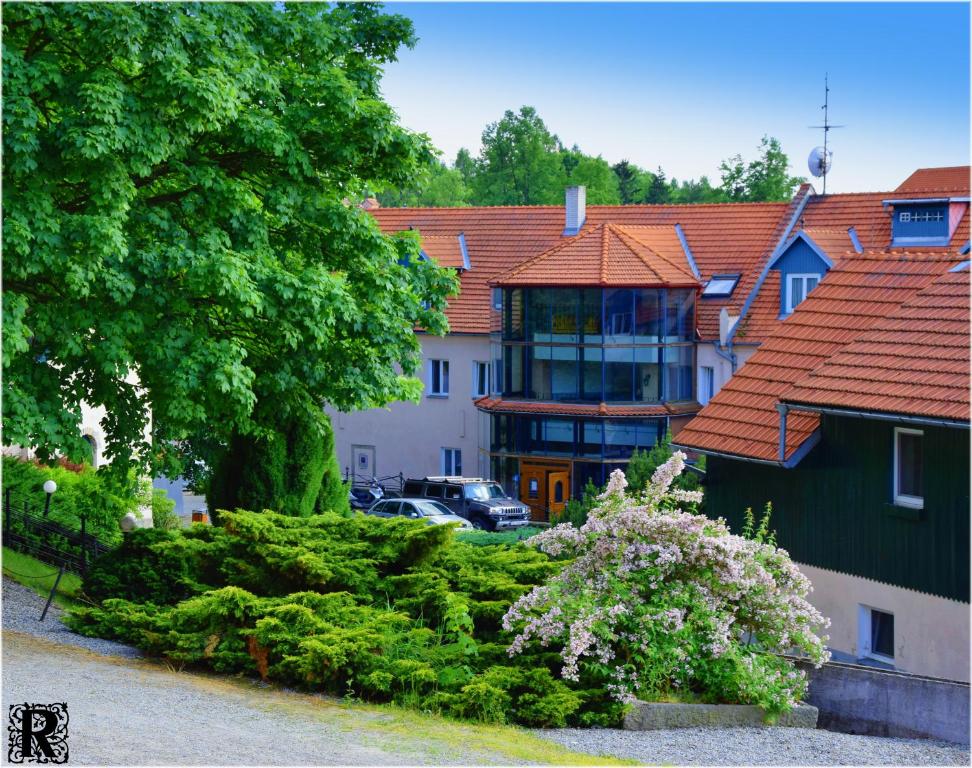 a house with a car parked in front of it at Hotel Rustikal in Horní Cerekev