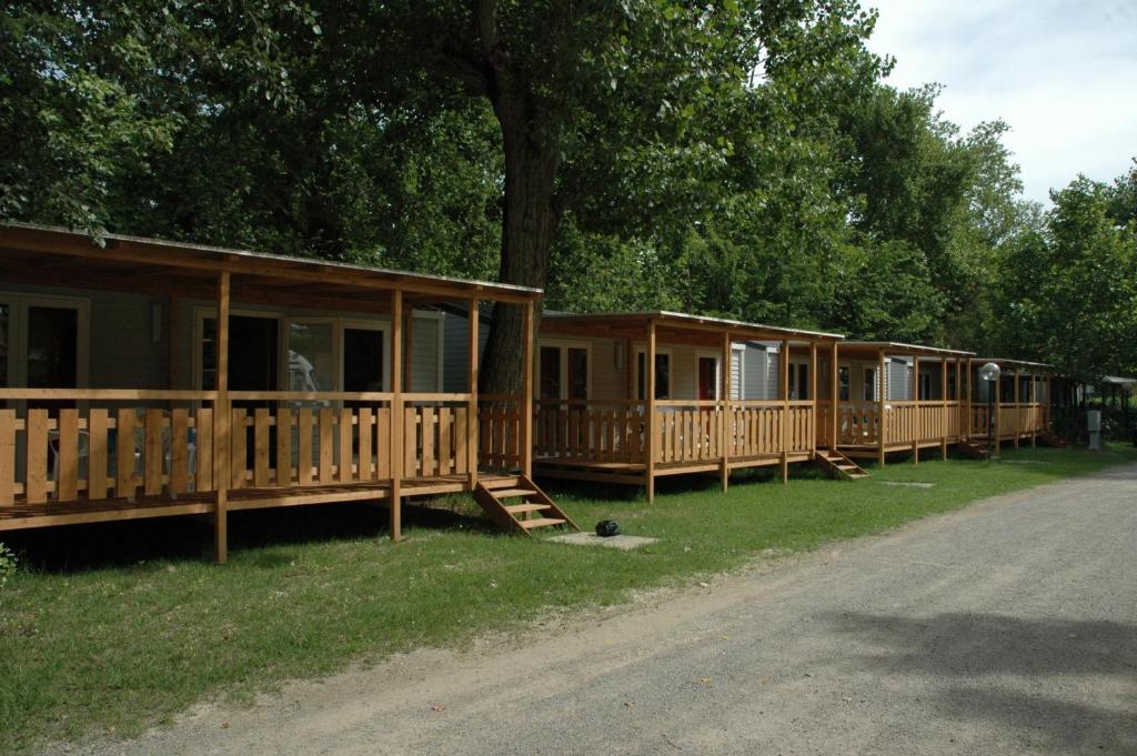 a row of modular homes on the side of a road at Camping Listro in Castiglione del Lago