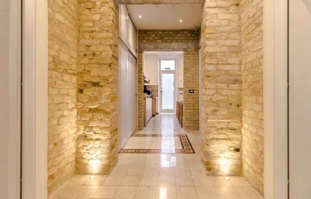 a hallway with stone walls and a tile floor at B&B Villa Ida Pescara Centro in Pescara