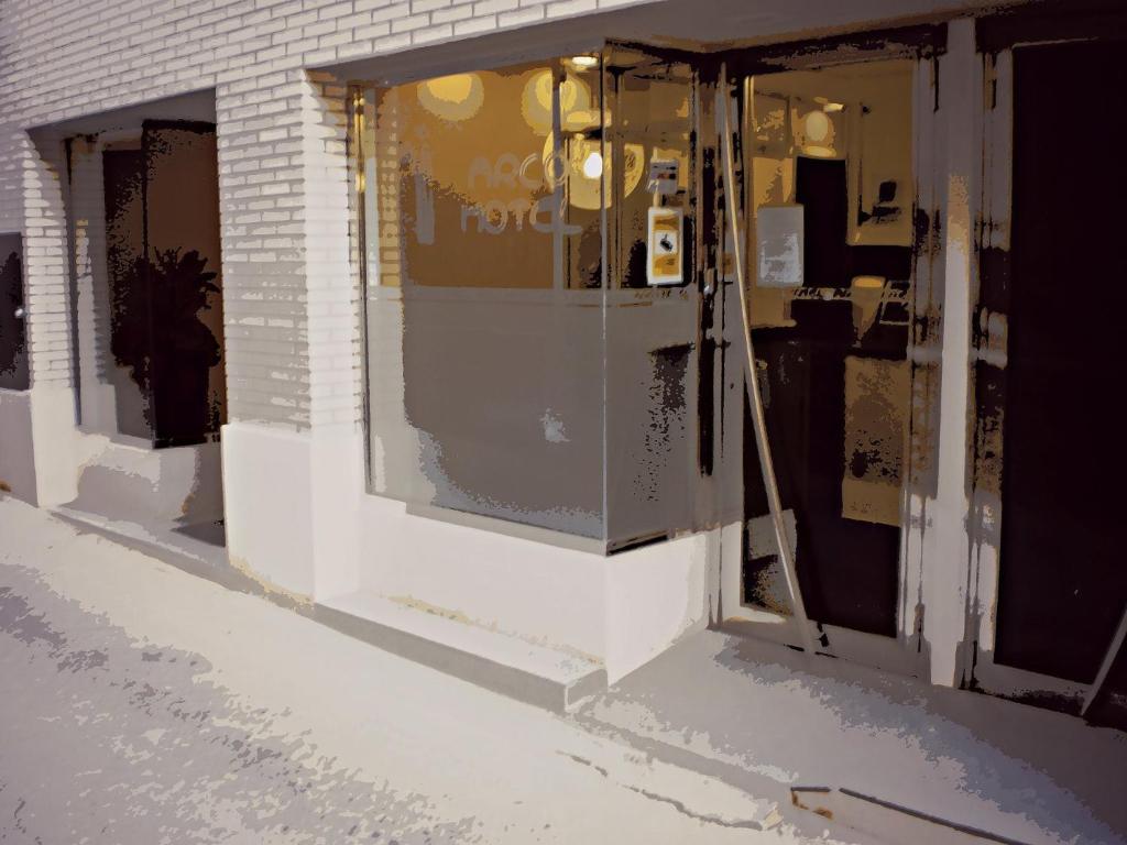 a store front with glass doors on a building at Arcohotel in San Mateo de Gállego