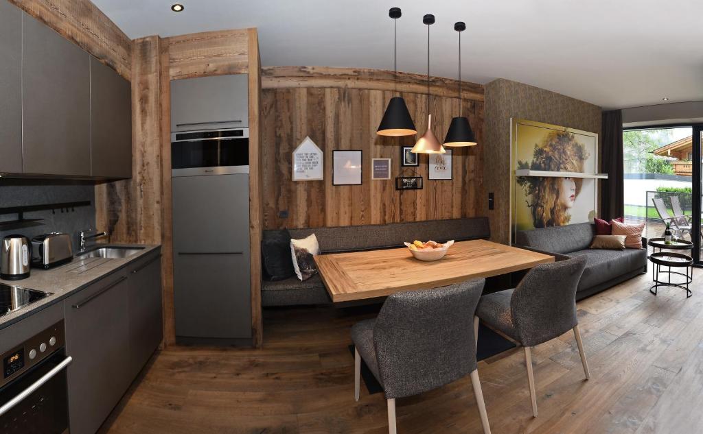 a kitchen and dining room with a wooden table at Postresidenz in Mayrhofen