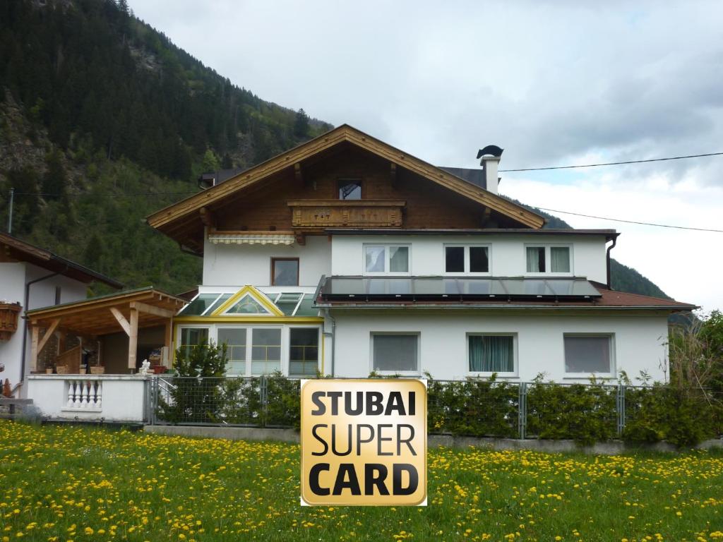 a sign in front of a house with a super card at Apart Toscana in Neustift im Stubaital