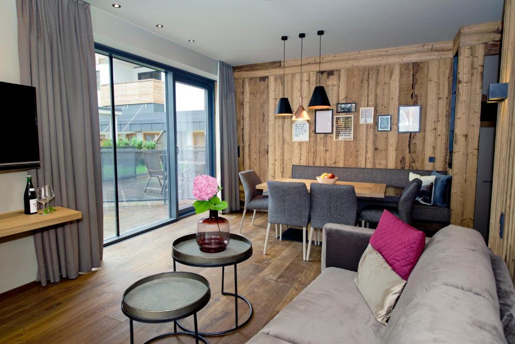 a living room with a couch and a table at Postresidenz in Mayrhofen