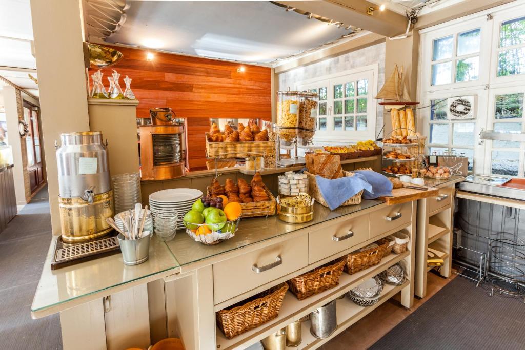 a kitchen with a counter with food on it at Boat Hotel De Barge in Bruges