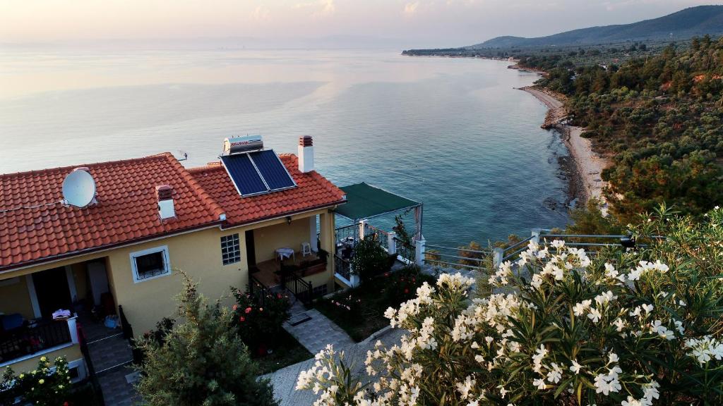 a house with a solar panel on top of the water at Aegean Colors in Skala Marion