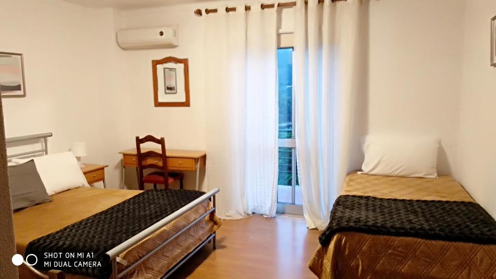 Postel nebo postele na pokoji v ubytování Residencial Do Rita em Rio Caldo