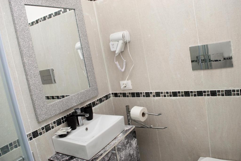 a bathroom with a sink and a mirror at Rome Sweet Home Vatican in Rome