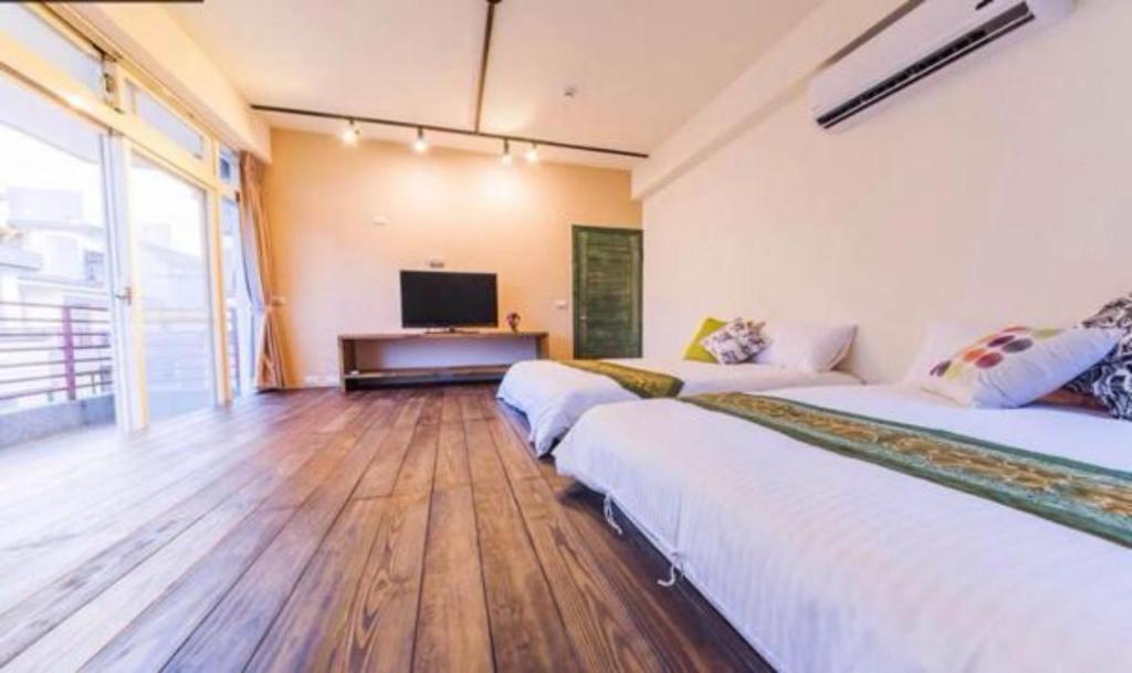 Postel nebo postele na pokoji v ubytování Yilan B&B - Happy Snail