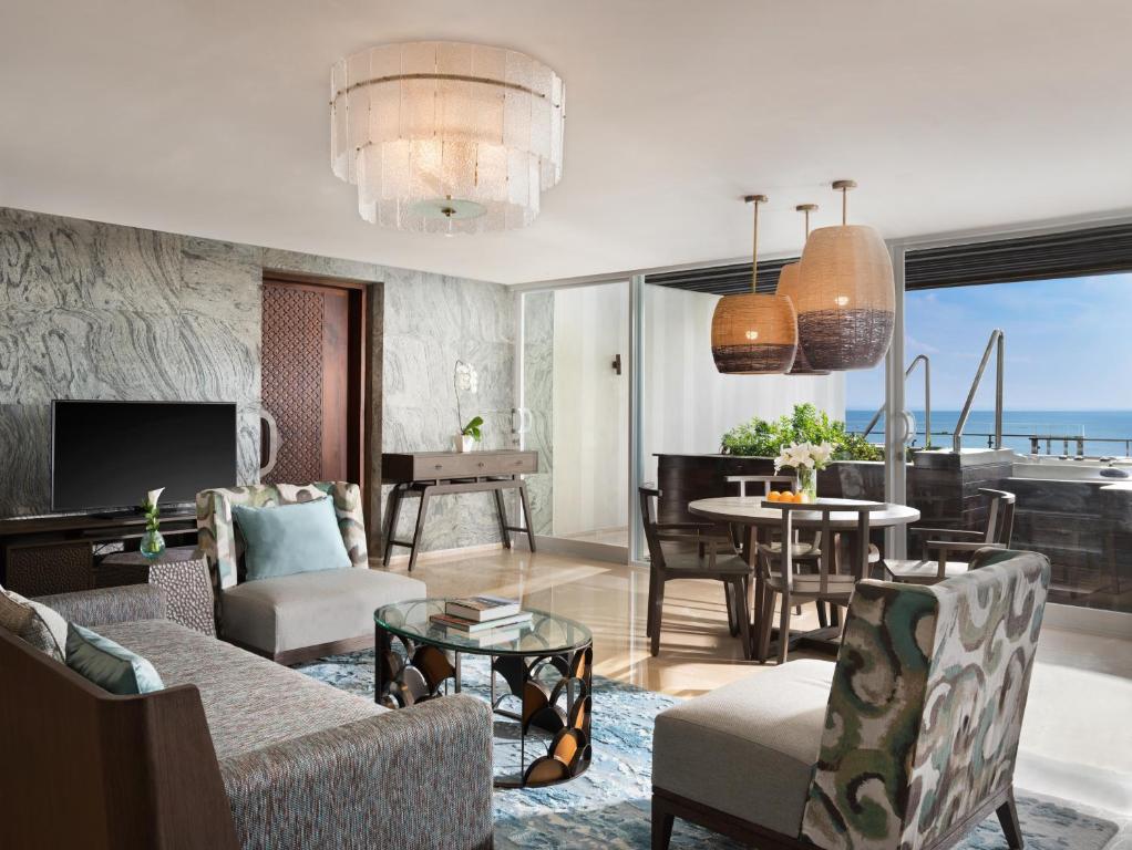 a living room with a couch and chairs and a table at Anantara Uluwatu Bali Resort in Uluwatu