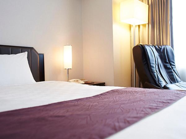 Postel nebo postele na pokoji v ubytování Hotel New Otani Takaoka