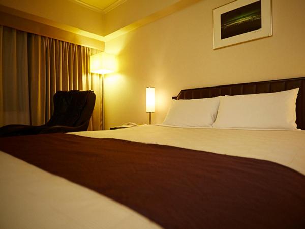 Postel nebo postele na pokoji v ubytování Hotel New Otani Takaoka