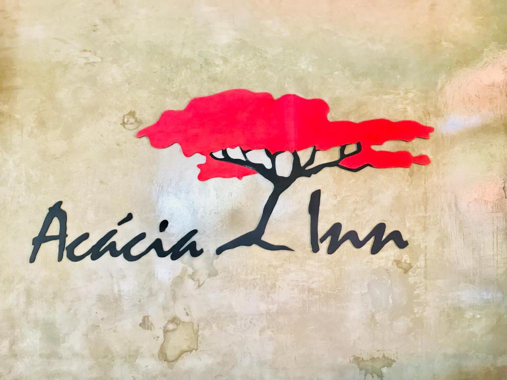 una pintura de un árbol rojo con las palabras Raiin inn en Acacia Inn GuestHouse, en Maputo
