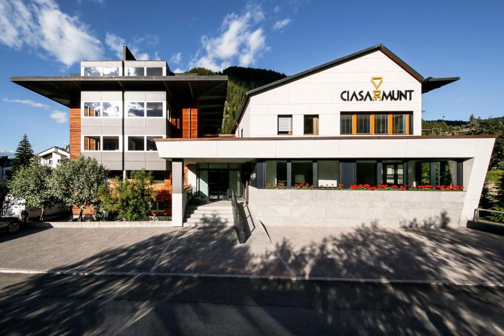 a building with a sign on the front of it at Ciasa de Munt Lifestyle Living in Corvara in Badia