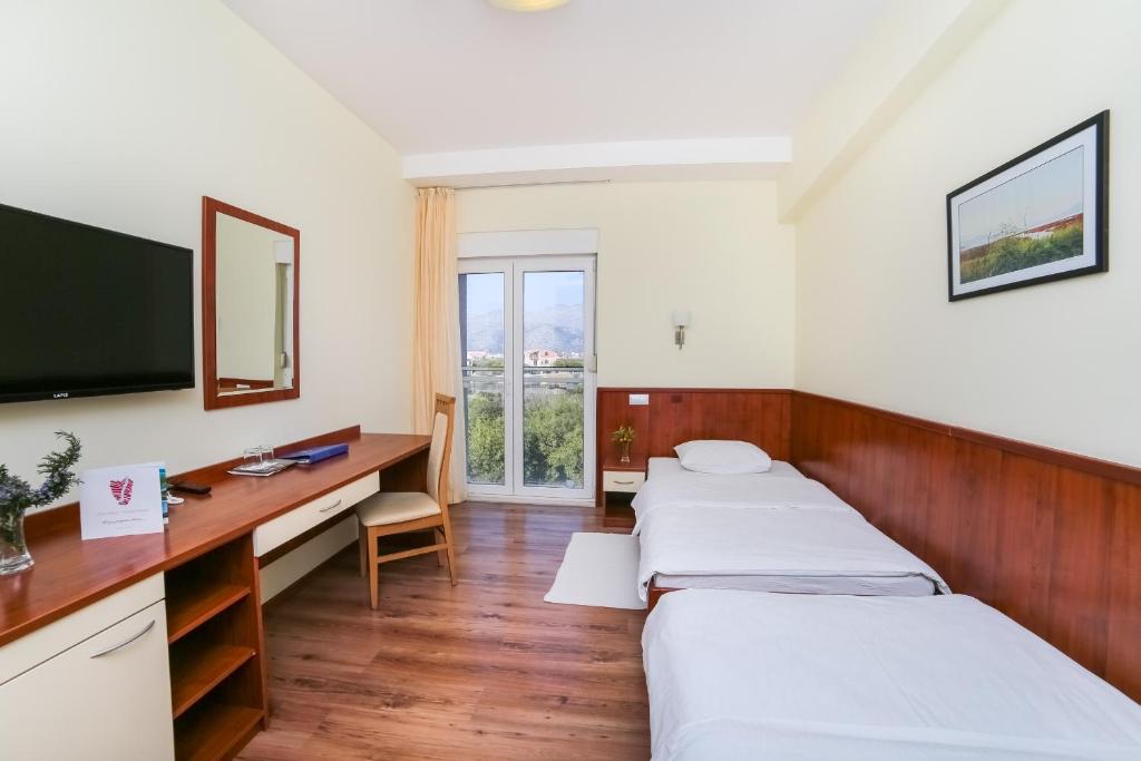 Postel nebo postele na pokoji v ubytování Hotel Merlot