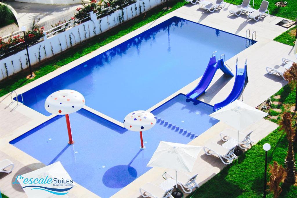 an overhead view of a swimming pool with umbrellas at L'escale Suites Résidence Hôtelière By 7AV HOTELS in Mohammedia