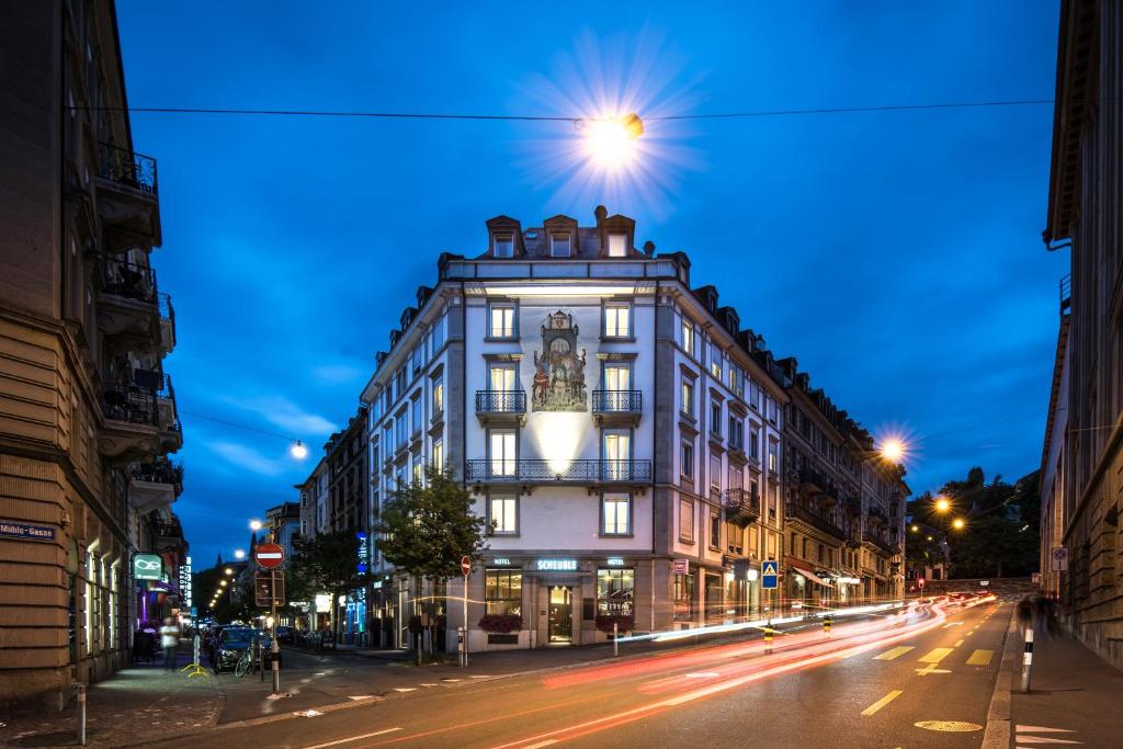 a building on a city street at night at Hotel Scheuble in Zürich