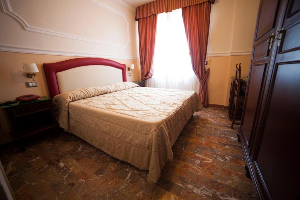 Postel nebo postele na pokoji v ubytování Hotel Gran Duca