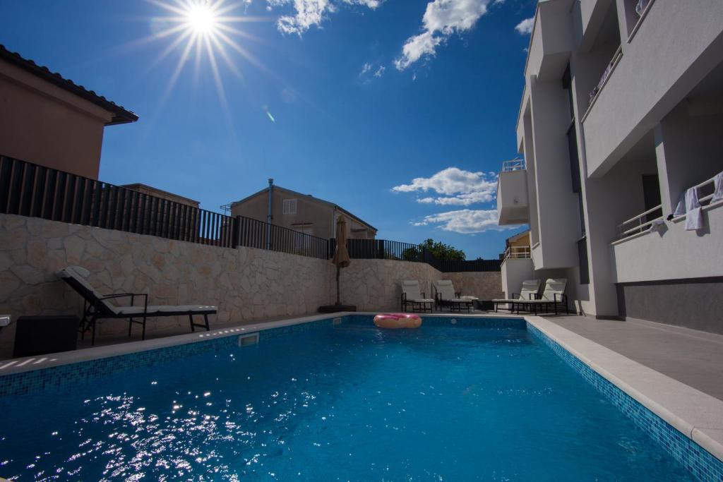 a swimming pool in the backyard of a house at Residences Bellavista 3 in Novalja