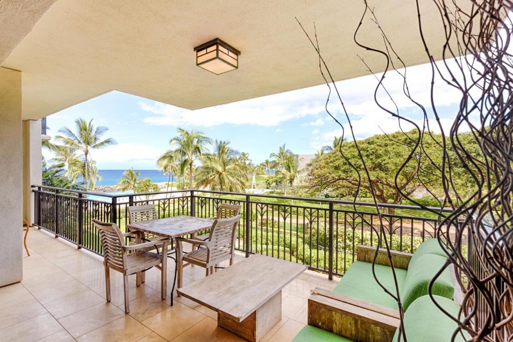 a balcony with a table and chairs and the ocean at Third Floor villa Ocean View - Beach Tower at Ko Olina Beach Villas Resort in Kapolei