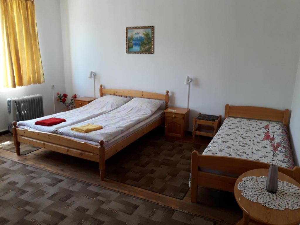 a bedroom with two beds and a table at Proboyski Guest House in Tryavna
