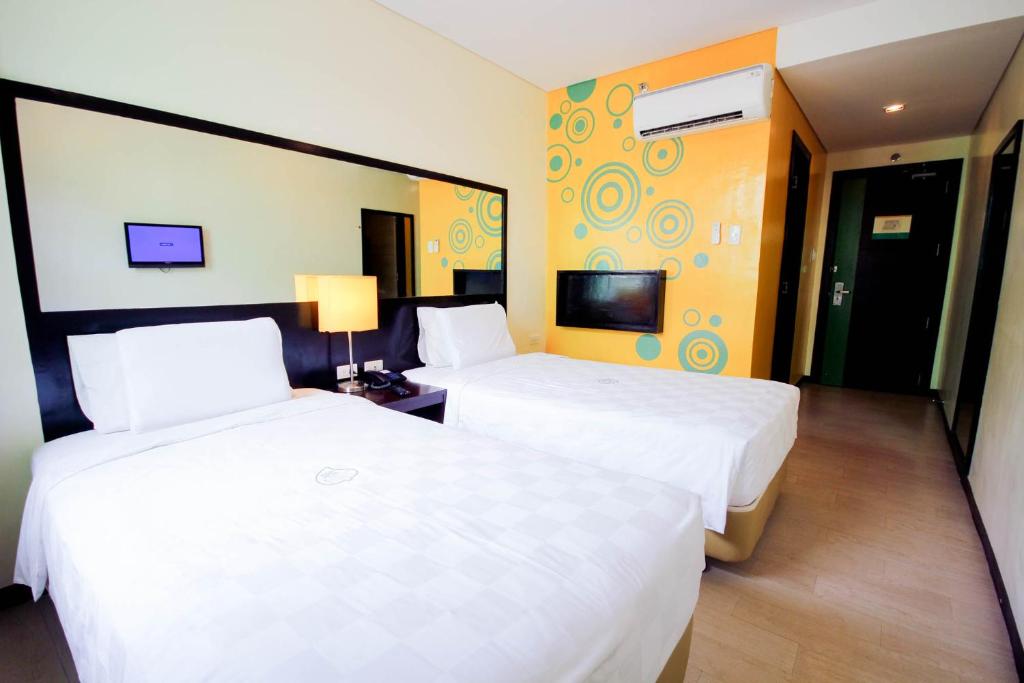 Postel nebo postele na pokoji v ubytování Go Hotels Puerto Princesa