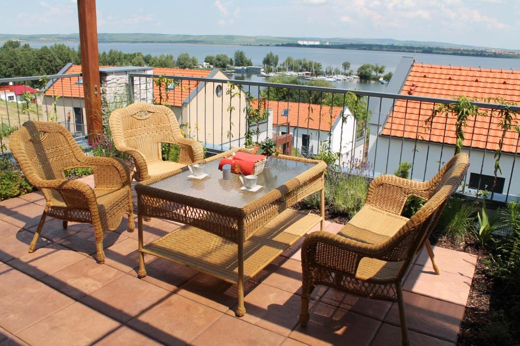 a patio with a table and chairs on a balcony at Apartmán Pálava - 1 in Pavlov