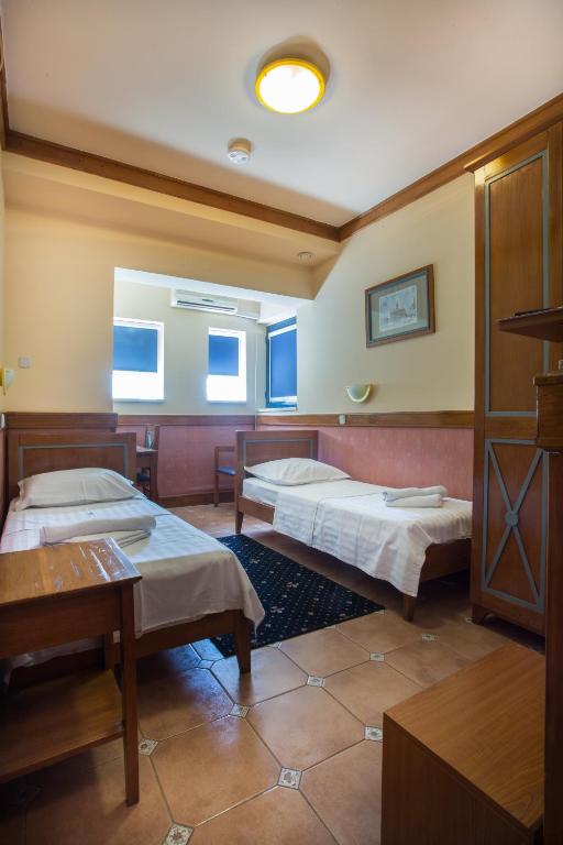Postel nebo postele na pokoji v ubytování Garni Hotel Zenit