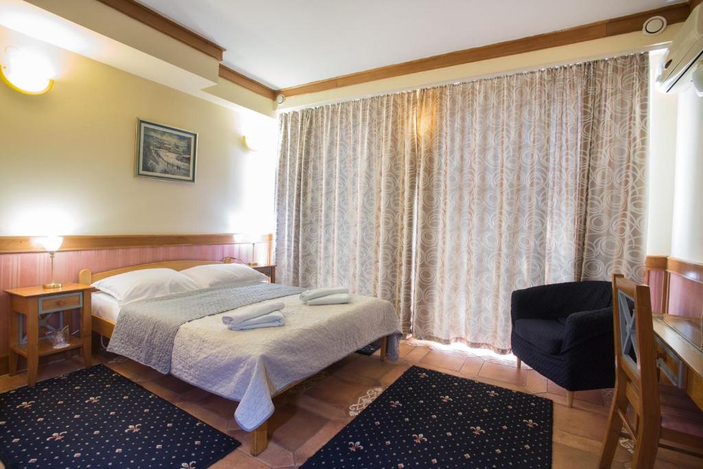 Postel nebo postele na pokoji v ubytování Garni Hotel Zenit