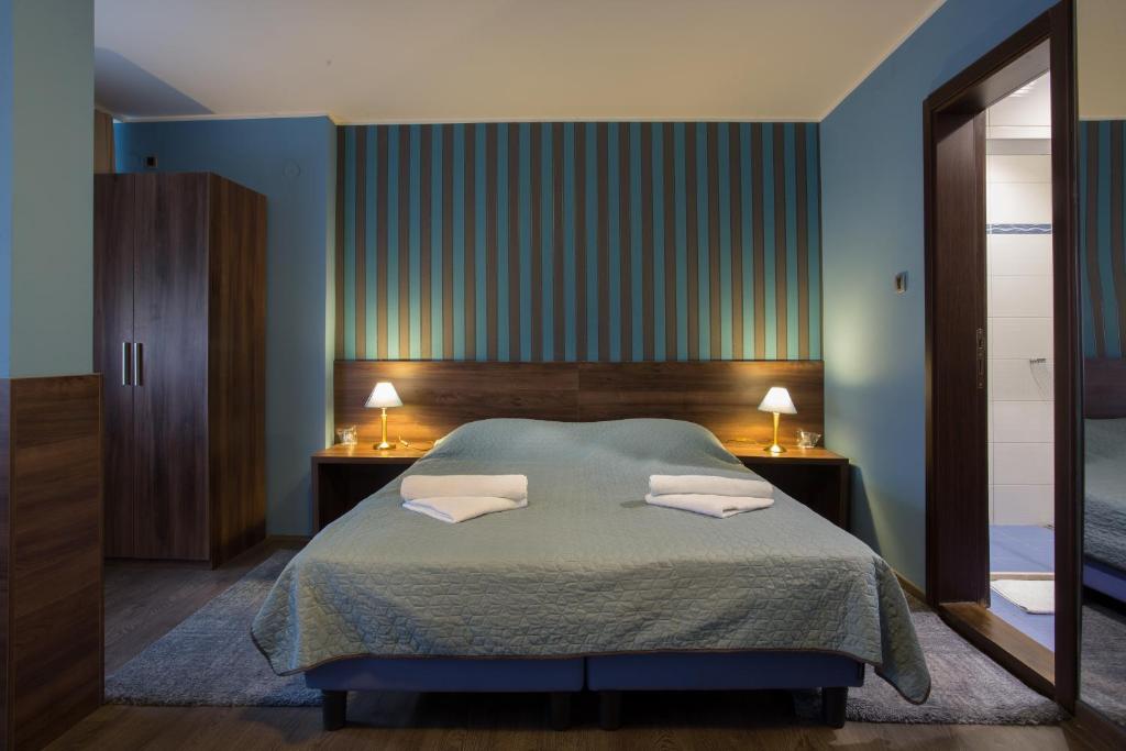 Postel nebo postele na pokoji v ubytování Garni Hotel Zenit