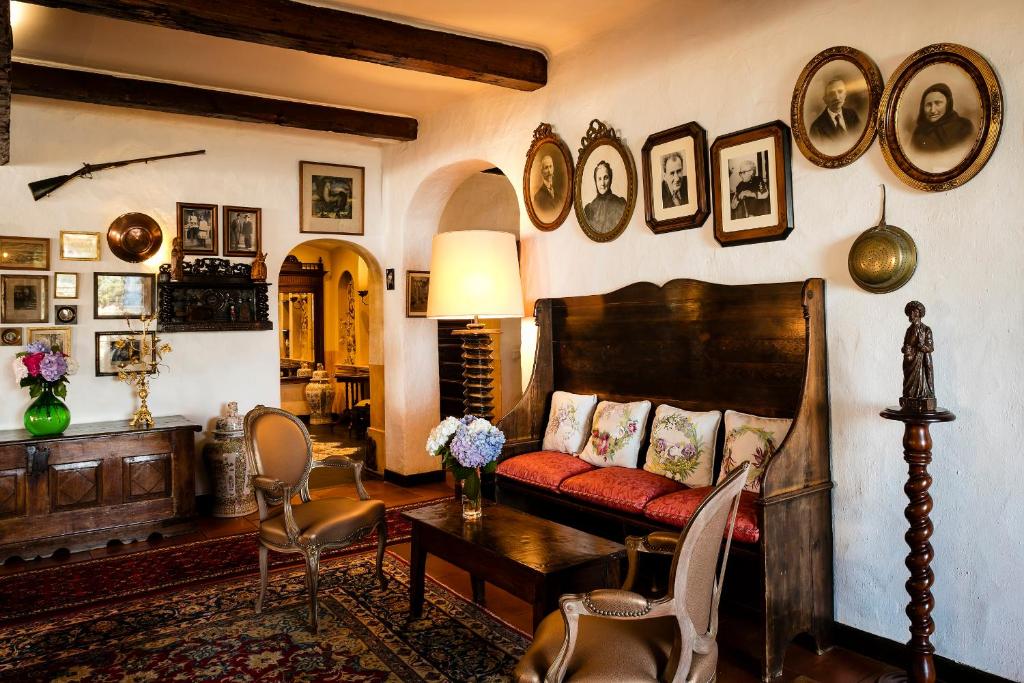 a living room with a couch and a table at Hotel Le Maquis in Porticcio