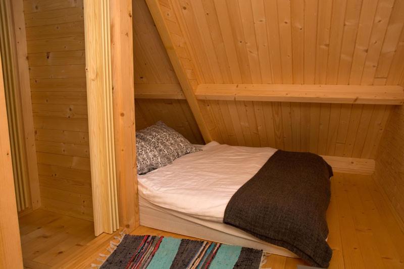 Postel nebo postele na pokoji v ubytování Domki Pod Sosnami