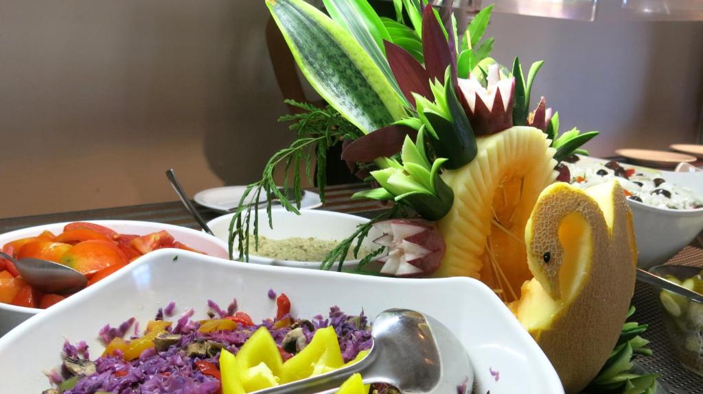 a table topped with bowls of food with fruit at Marina Hotel in Ayia Napa