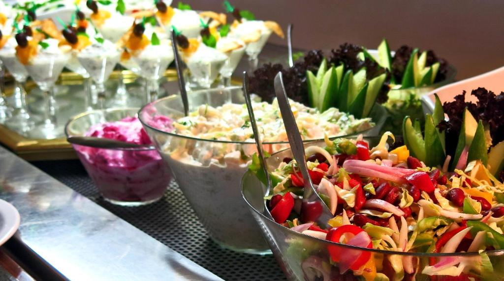 a table topped with bowls of different types of food at Marina Hotel in Ayia Napa