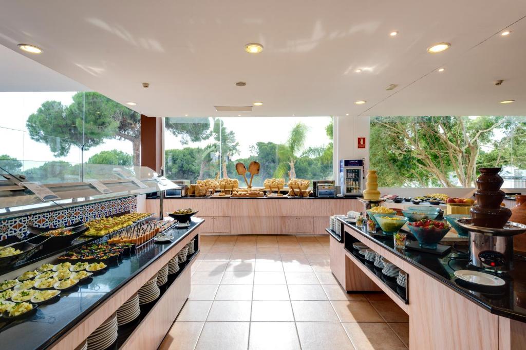 a buffet line with many different types of food at Garden Playanatural - Adults Only in El Rompido