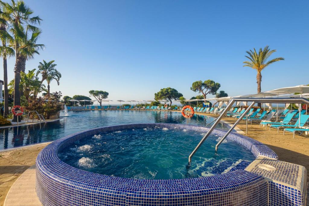 a large swimming pool with a large swimming pool at Garden Playanatural - Adults Only in El Rompido