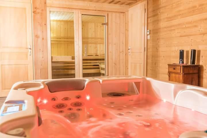 a bath tub in a room with a sink at La Coulée Douce in Lanslevillard