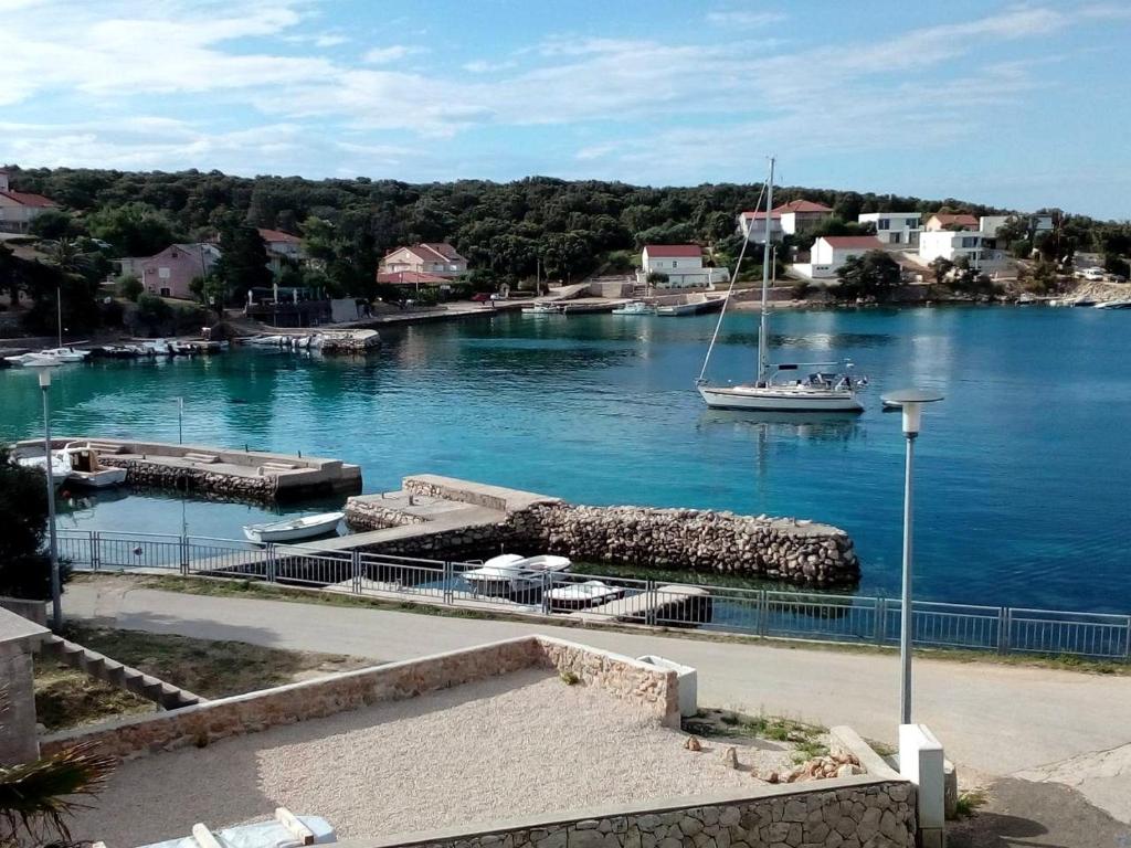 Ein Boot liegt an einem Dock im Wasser. in der Unterkunft Apartment Dora 1 Jakišnica in Lun