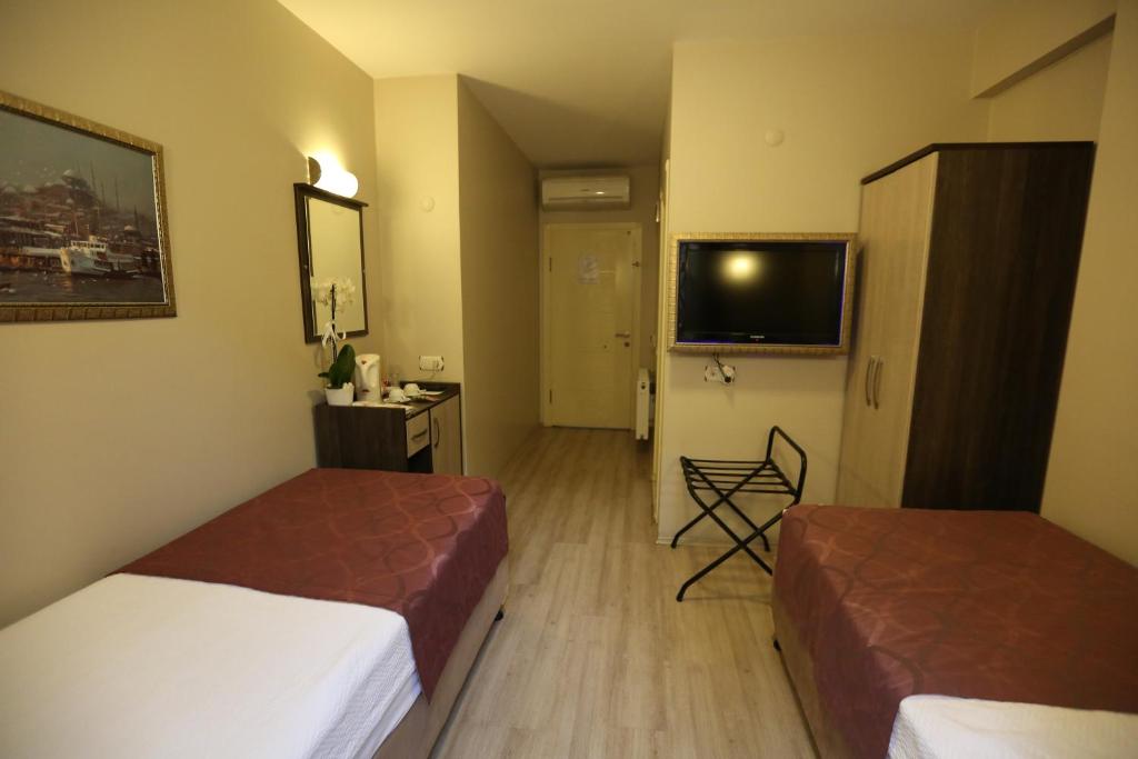 Postel nebo postele na pokoji v ubytování Canakkale Bogaz Hotel