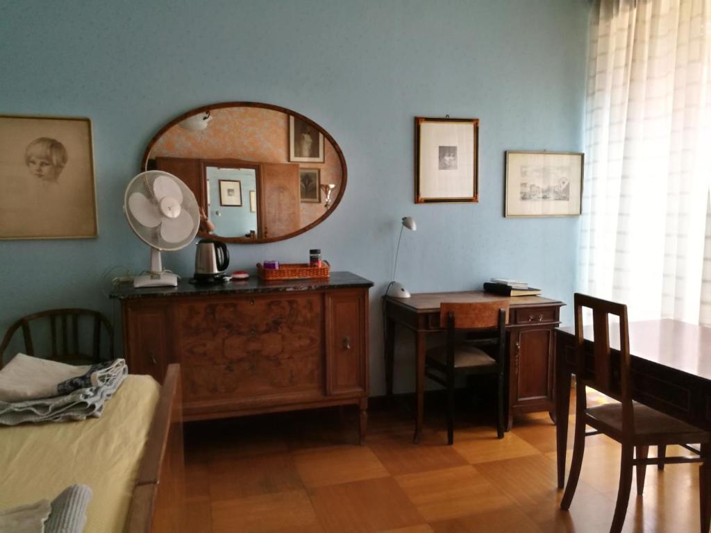 um quarto com uma mesa, um espelho e uma secretária em big room in Milano center em Milão