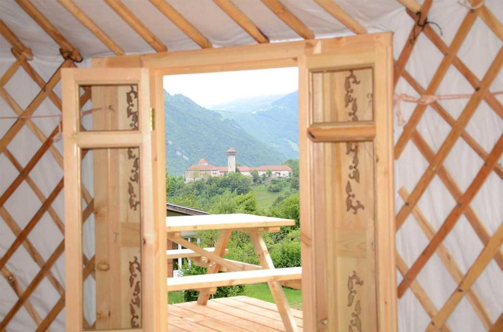 an open door to a yurt with a view at Yourtes Olachat proche Annecy in Faverges