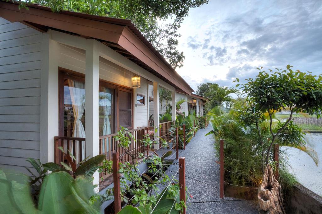 a house with a porch with plants on it at The Studio in Seminyak