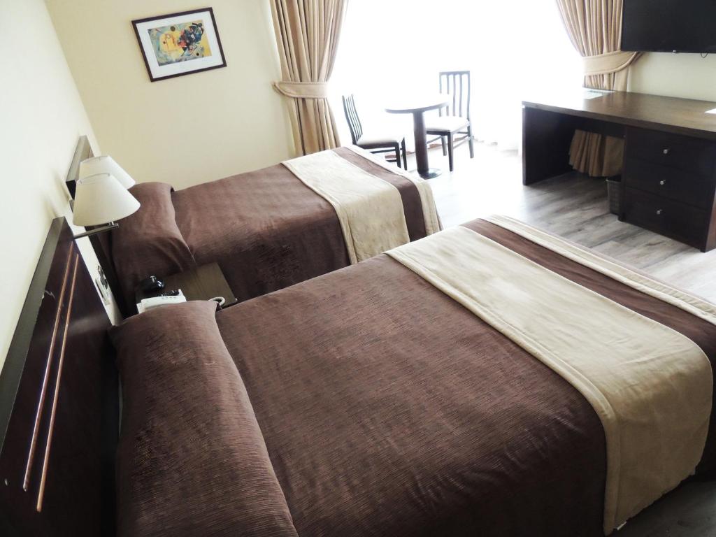 Postel nebo postele na pokoji v ubytování Hotel Diego de Almagro Valparaíso