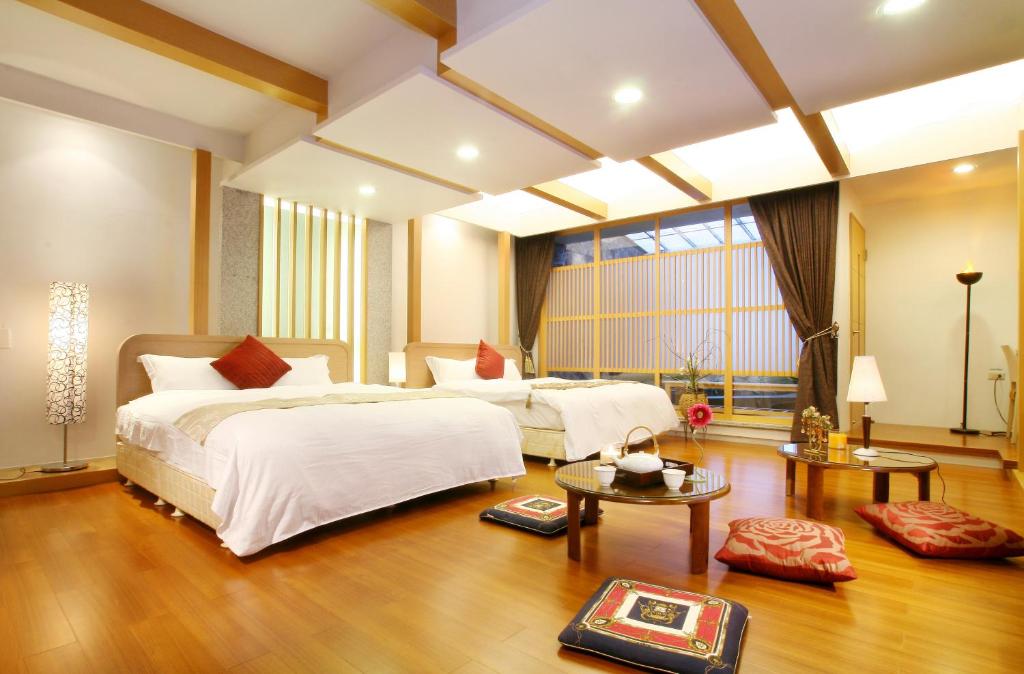 礁溪鄉的住宿－映象函館溫泉，一间大卧室,配有两张床和一张桌子