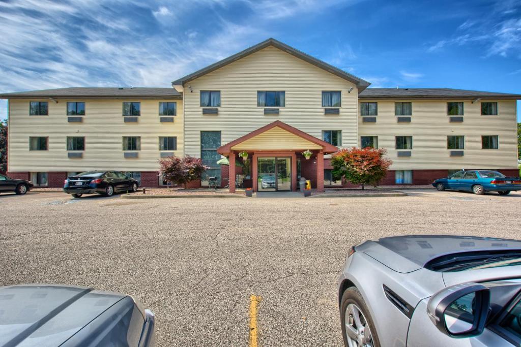 a large building with a car parked in front of it at Rodeway Inn in Whitehall