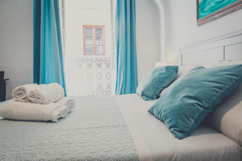 a white bed with towels and pillows on it at Il Gattopardo B&B in Florence