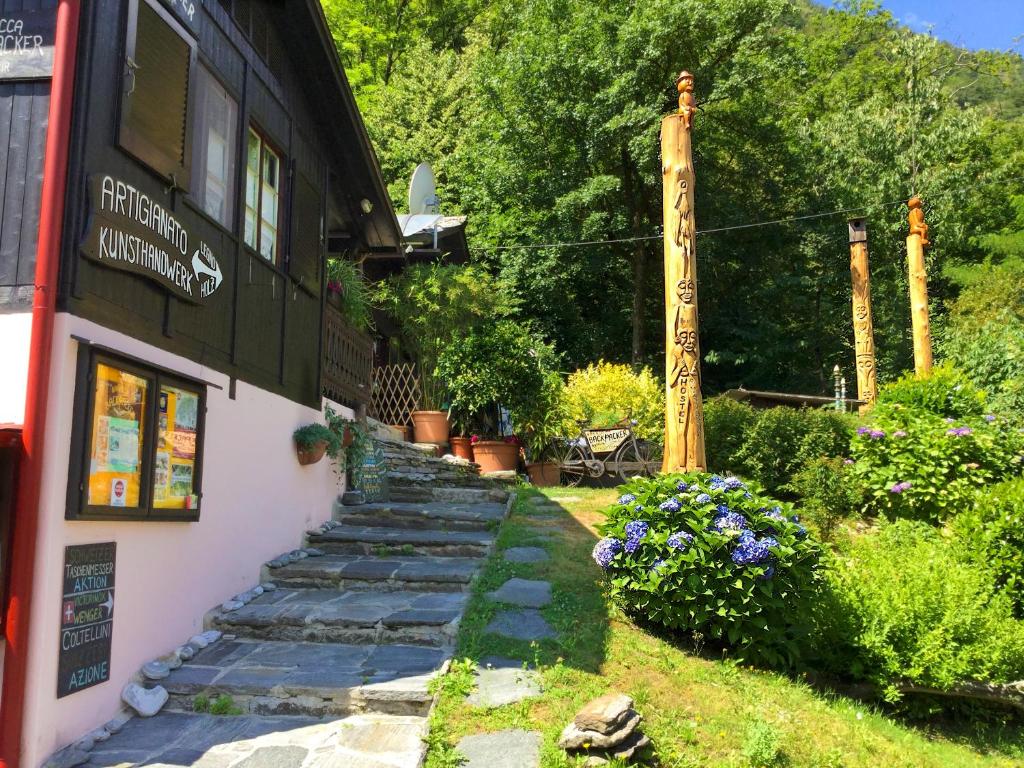 a stone path leading to the side of a building at Baracca Backpacker in Aurigeno