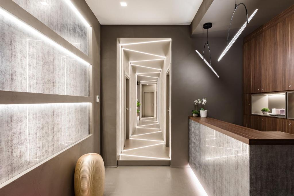a hallway with a door leading into a kitchen at A World Aparts - Barberini Boutique Hotel in Rome