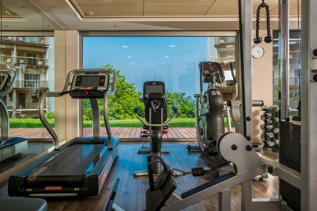 a gym with two tread machines and a large window at Hotel Santa Marta in Lloret de Mar